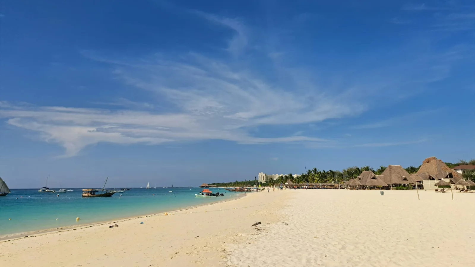 White sand, boats and thatched roofs at Kendwa Beach